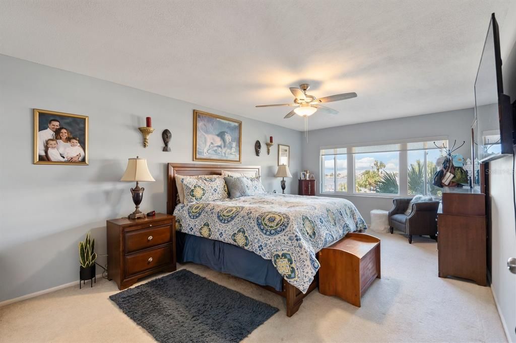 Primary Bedroom with a sitting area and View of Sunsets and the Intercoastal