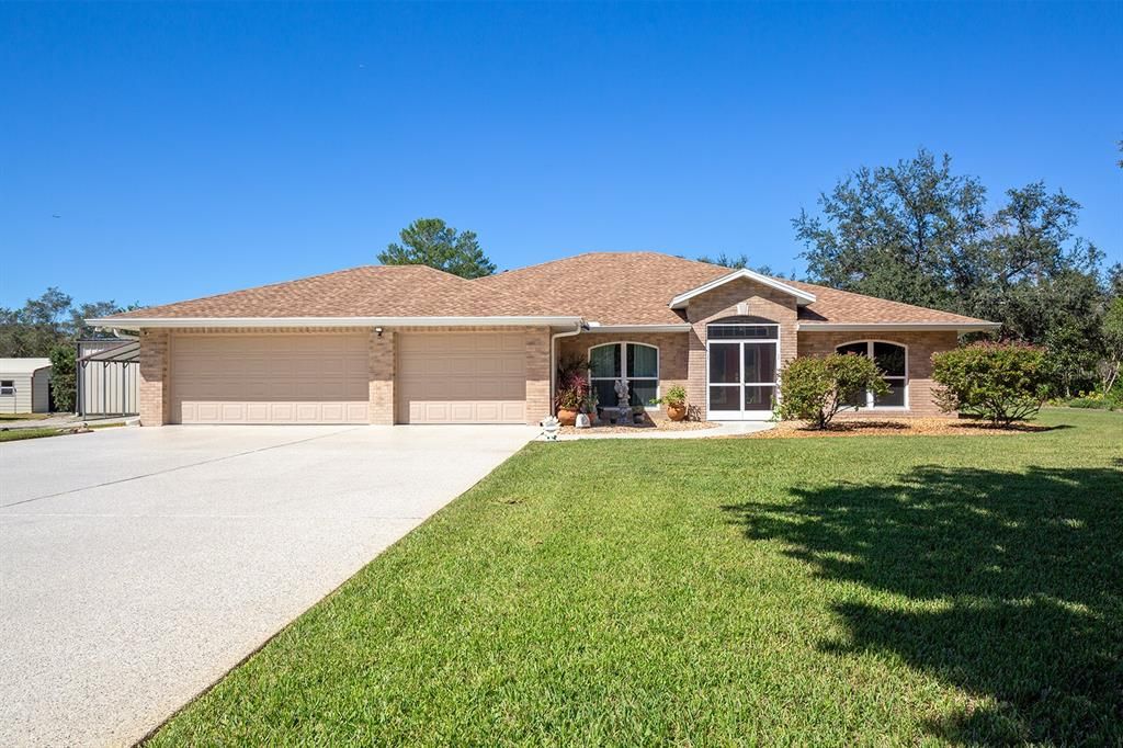 Look at this curb appeal and 3 Car Garage!