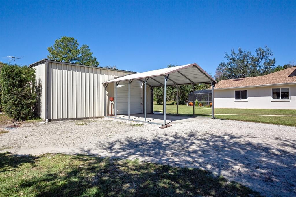 Extra tall carport leading to the 30x30 Workshop!