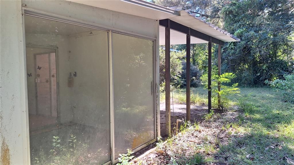 Several Glassed in Aluminum Rooms surround the house