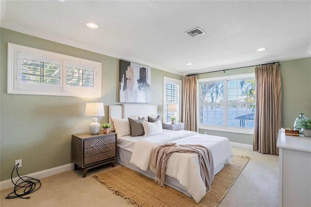 Your master suite is a true sanctuary, with a wall of windows overlooking the backyard showcasing panoramic lake views.