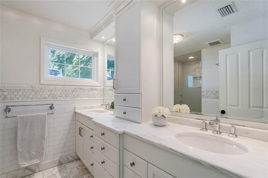 The en-suite master bathroom has been tastefully updated with a newly re-tiled shower, dual sinks, and a walk-in closet that fulfills your every storage need.