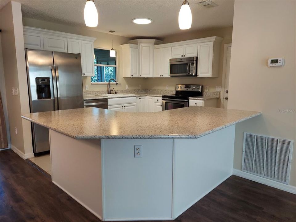 KITCHEN HAS LARGE COUNTER FOR ENTERTAINING