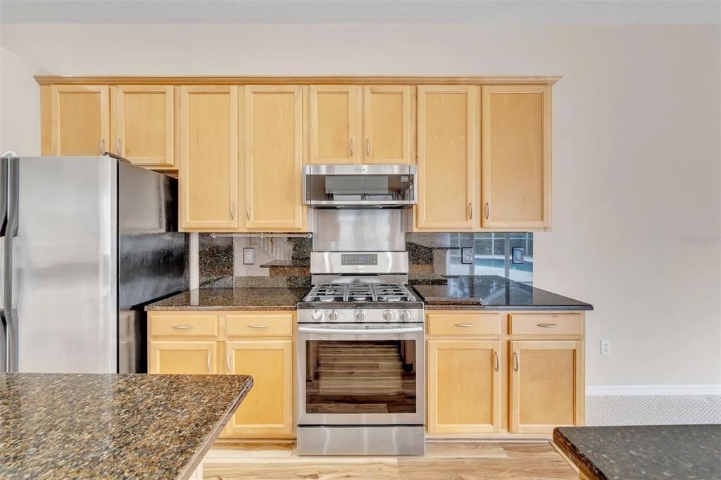 Kitchen with Granite countertops and backsplash