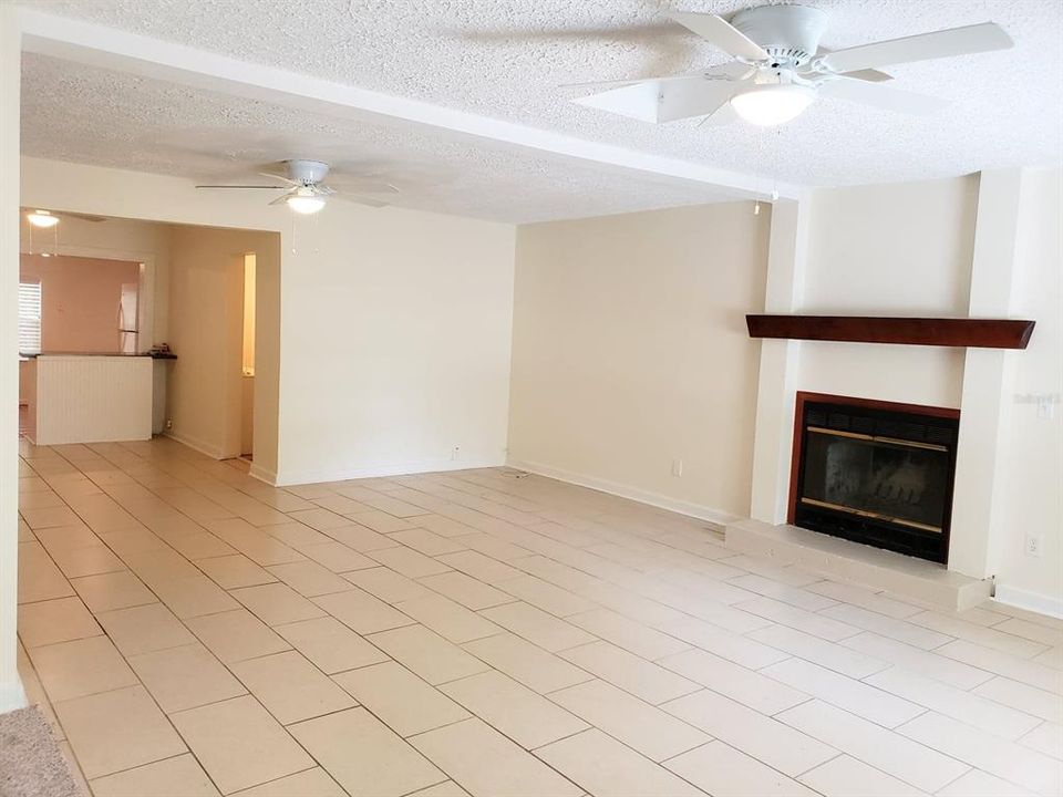 Large living room with wood burning fireplace