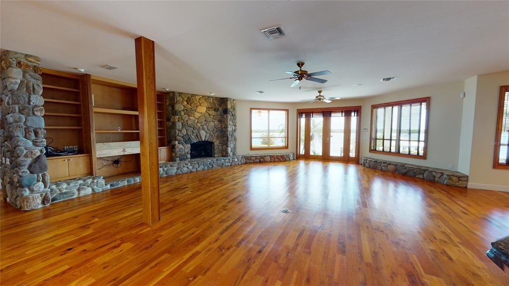 Open foorplan with stunning views of the river from the front door entrance! Beautiful wood floors, Two gas fireplaces surrounded by river stone & built in shelves.