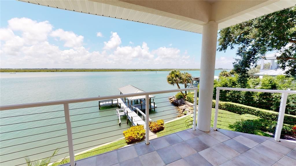 2nd floor tiled balcony features magnificent views of the intracoastal & your private boat dock.