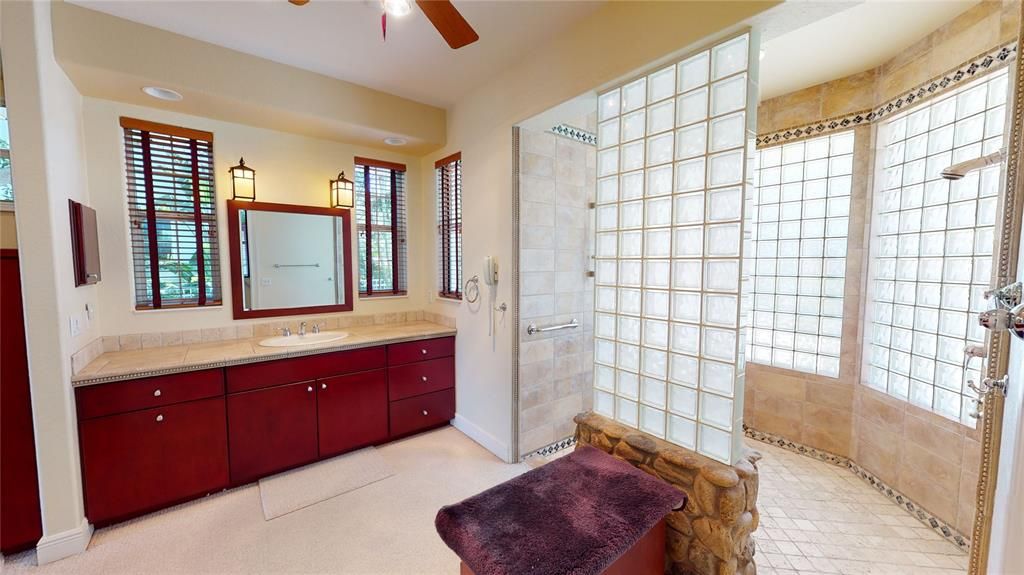 Master bath features double vanities & a spacious glass block shower with two shower heads.