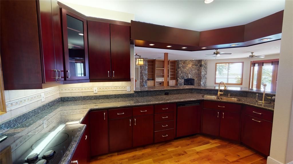 Gourmet chefs kitchen has granite counters, wood cabinets with pull out drawers, under & over cabinet lighting & and huge pantry.