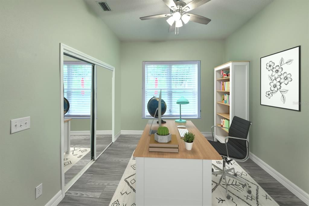 Guest bedroom with double door entry and mirrored glass closet doors.