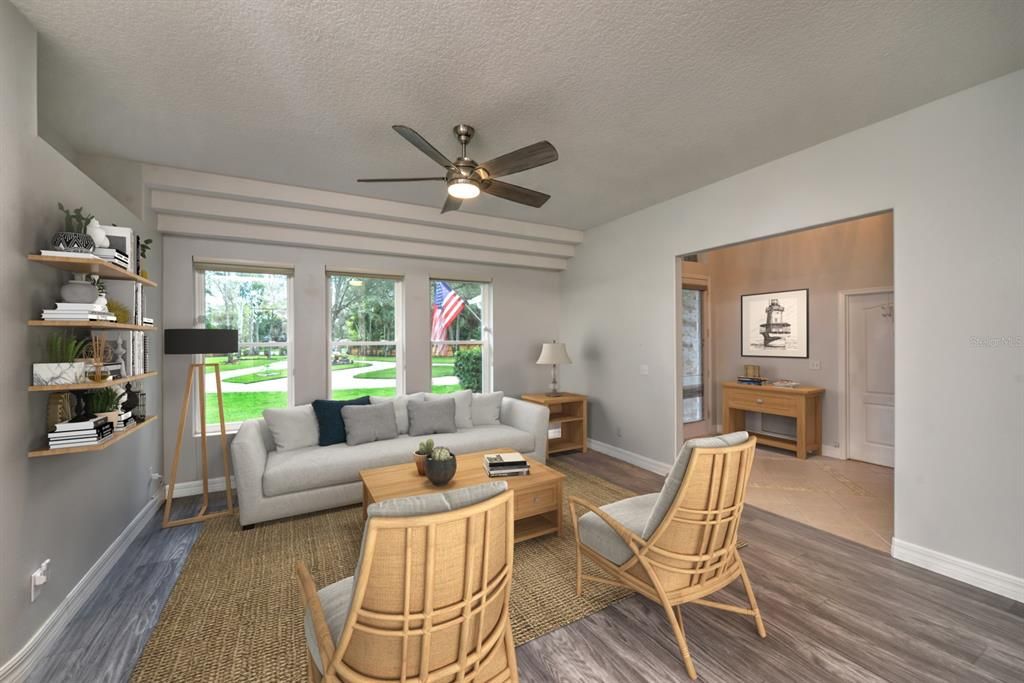 Spacious living room with architectural wall design and 3 big windows looking out to the front yard.