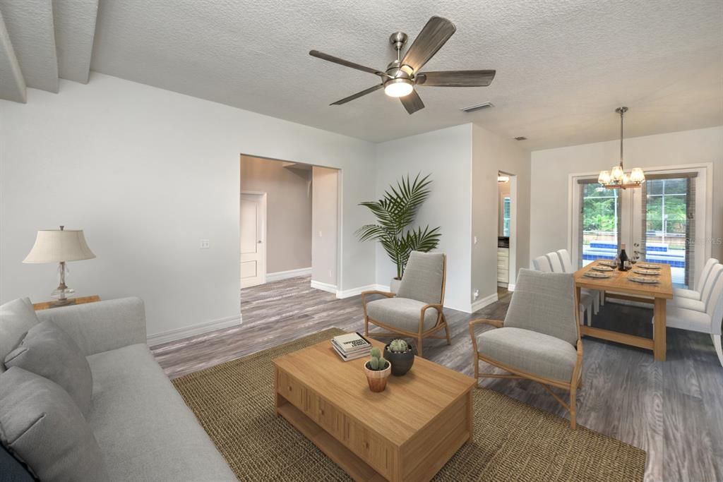 Living room/dining room combo. French doors off dining area open up to covered lanai & pool area making it perfect for entertaining.