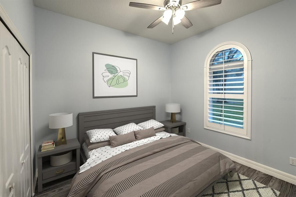 Guest bedroom with plantation shutters overlooks the backyard.