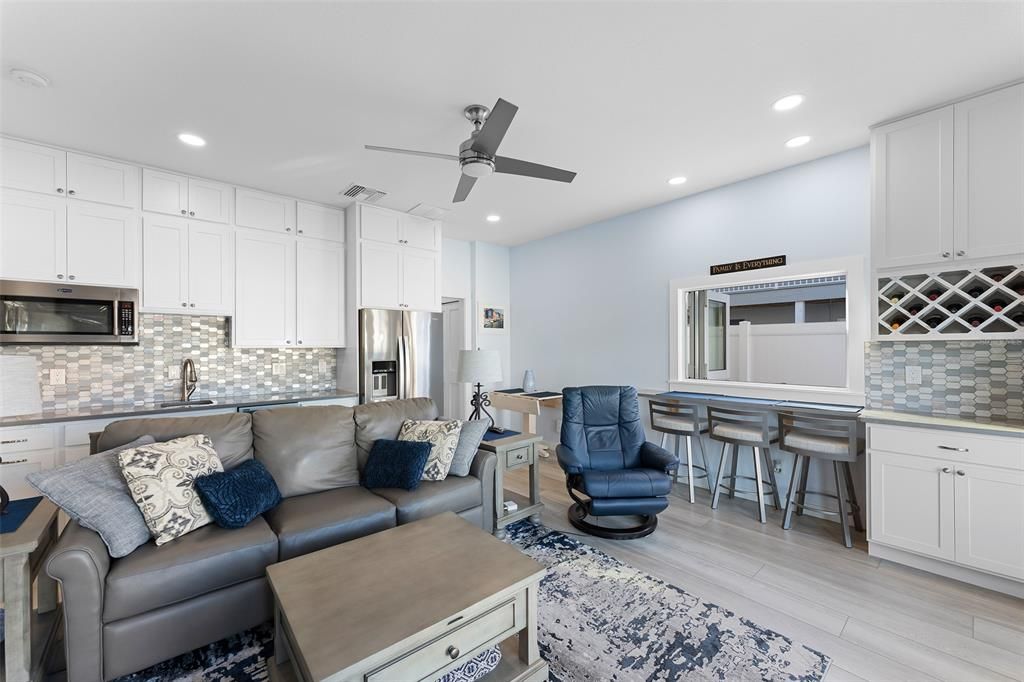 FIRST LEVEL KITCHEN WITH FULL SIZE REFRIGERATOR, MICROWAVE AND A SUPER HANDY DISHWASHER...NOTE THE INDOOR BARSTOOLS WITH FULL SLIDING WINDOW...