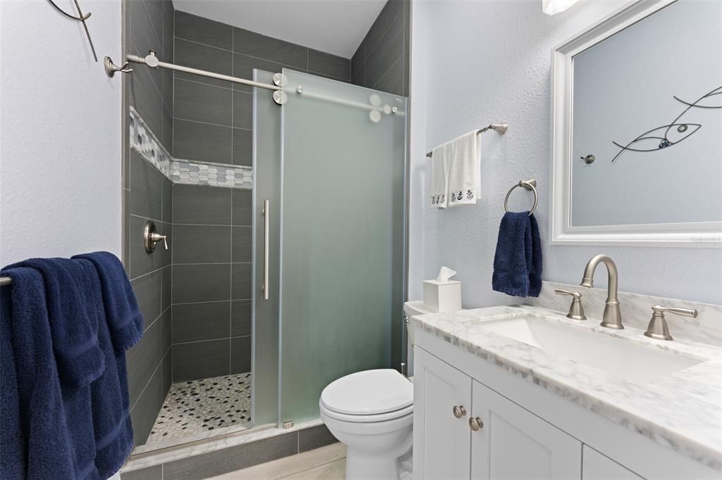 GORGEOUS FIRST LEVEL BATHROOM, NOTE THE TALL CEILINGS.