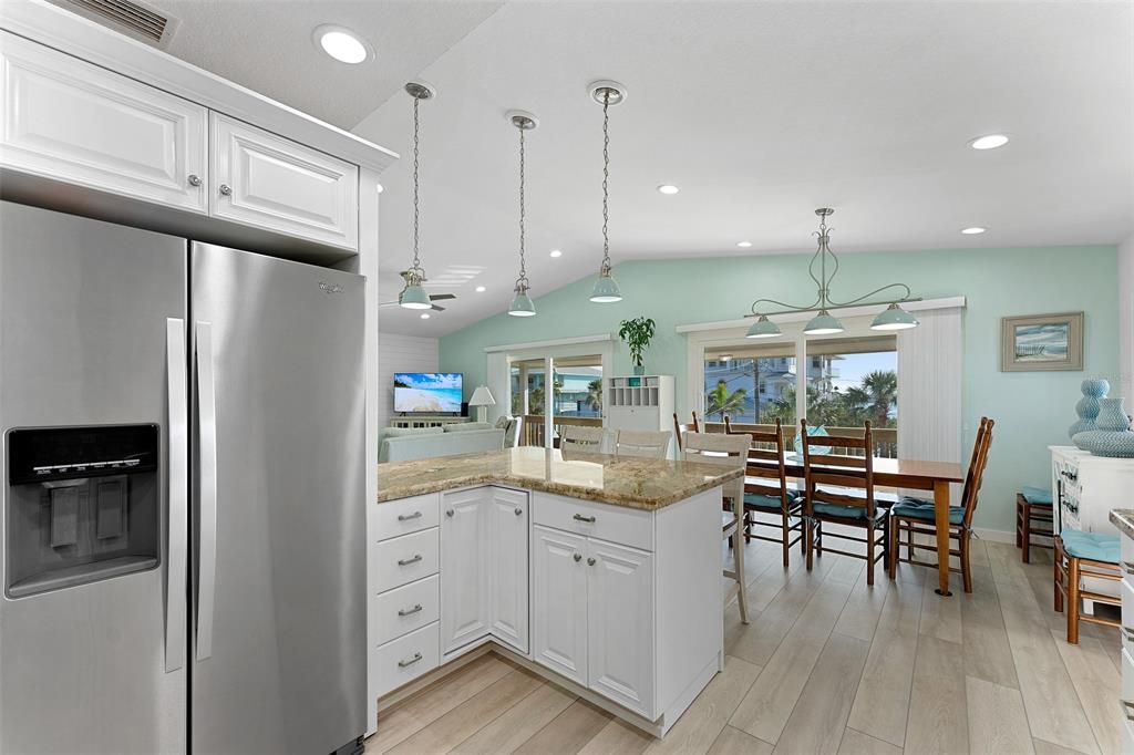 KITCHEN ISLAND BY DINING TABLE WILL ACCOMODATE 3 OR 4 HUNGRY GUESTS! LOTS OF COUNTER SPACE FOR A BUFFET STYLE MEAL TOO!