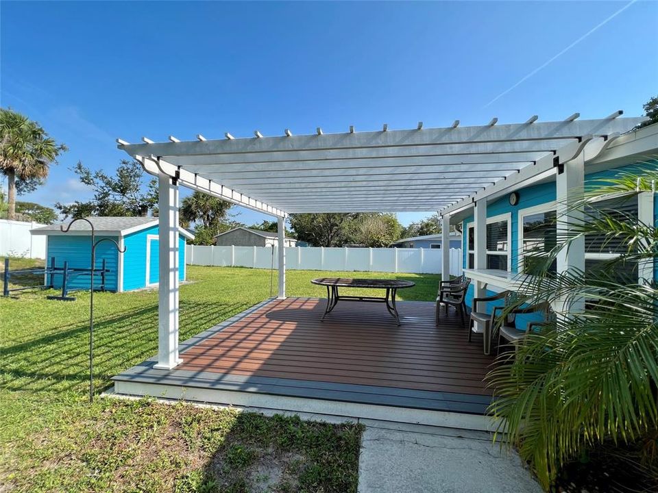 N Back porch, pergola and storage shed.