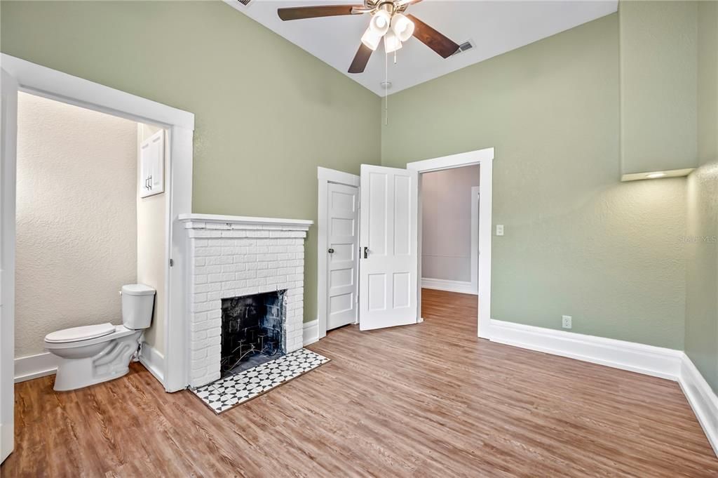 Guest bedroom with half bath and fireplace