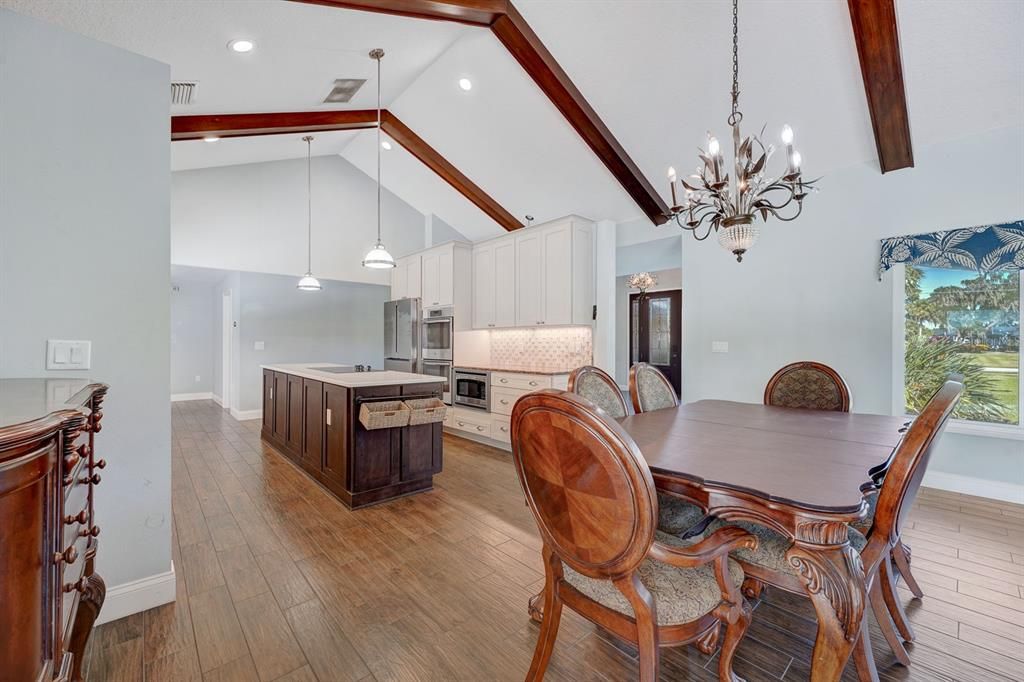 Kitchen area w/gourmet Island.  Wellborn cabinetry, pendant lighting, walk in pantry. Bosch refrigerator. Bosch dishwasher.