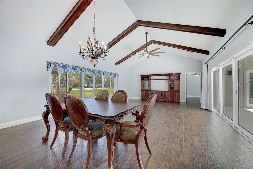 Open area for dining, entertaining and hide-away sliders open onto oversized lanai onto deck and pool area. Great for entertaining with outdoor summer kitchen.