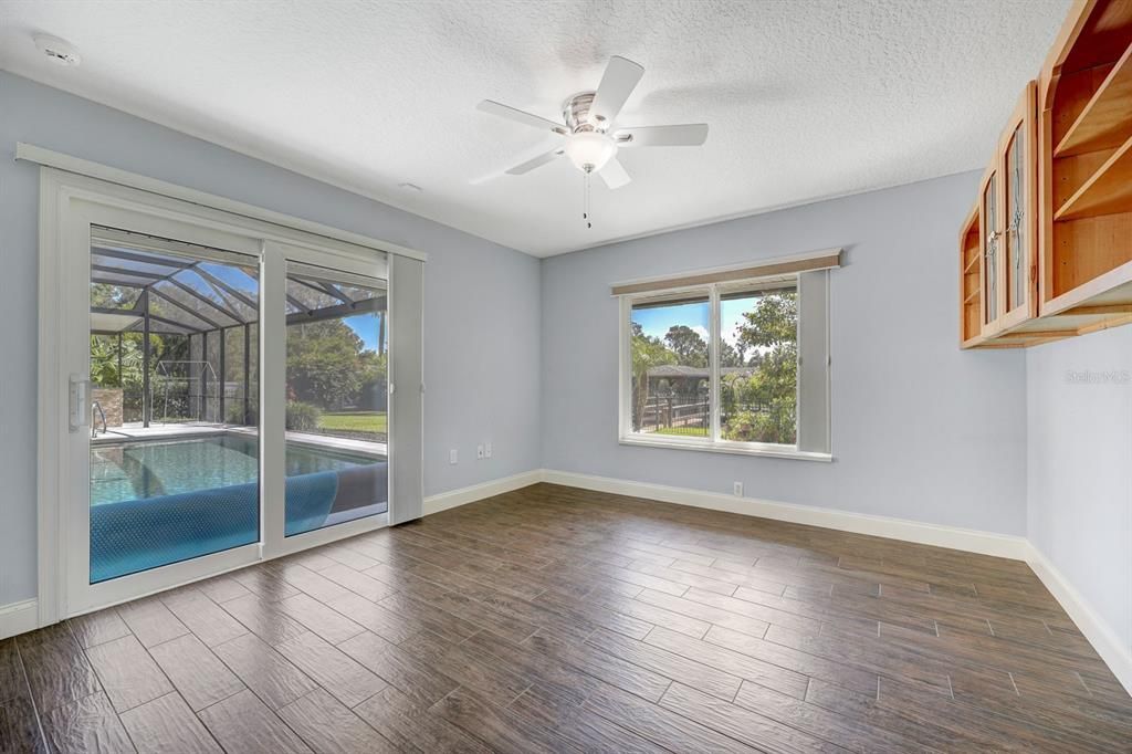 Bedroom #2 12'2 X 12'9  Blackout shades on window and sliders to pool area. Bedroom has custom cabinets built in.