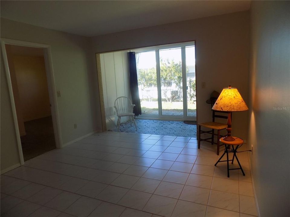 Living room toward Enclosed porch with new Storm rated sliders AND Laundry closet