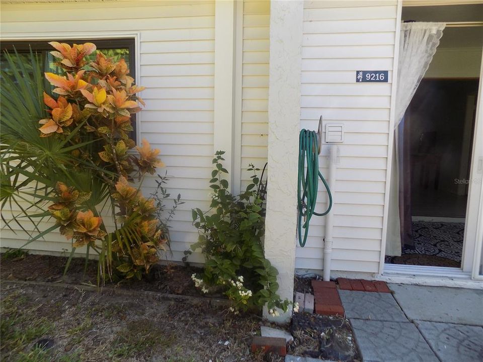 Condo unit's Back Patio off Sunroom Enclosed Porch.