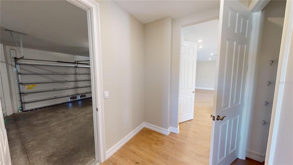 Garage foyer with utility closet, laundry and garage access