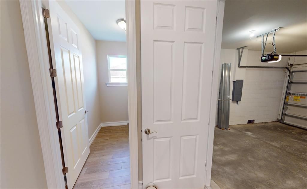 Garage foyer with utility closet, laundry and garage access