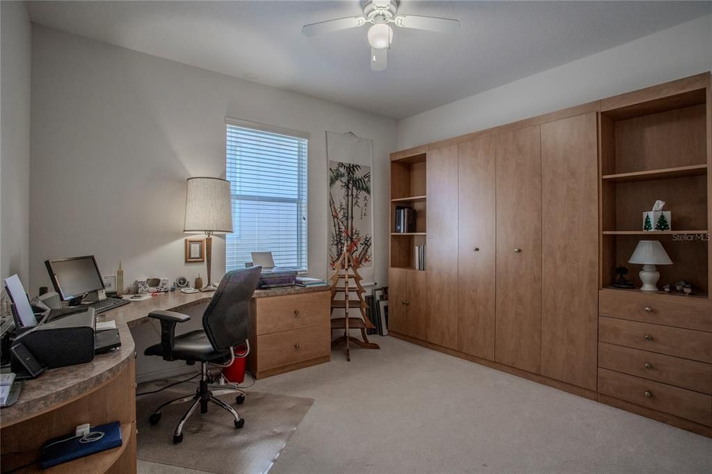Bedroom 3/Office with beautiful built-in cabinetry, Murphy bed, and desk.