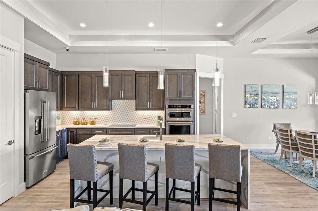 Kitchen with beautiful quartz, stainless steel appliances.