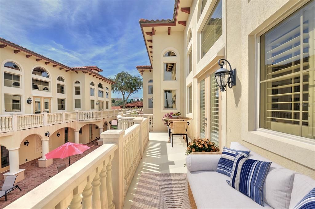 Balcony overlooks downstairs lanai and pool area.