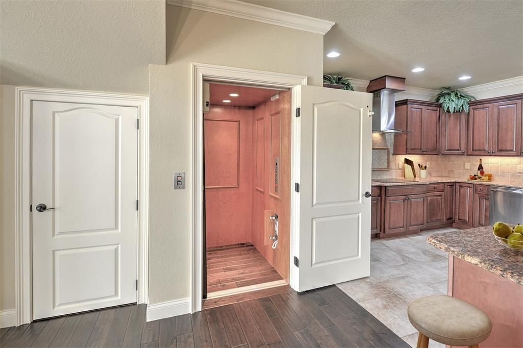 Main floor elevator. Storage room located under the stairway.