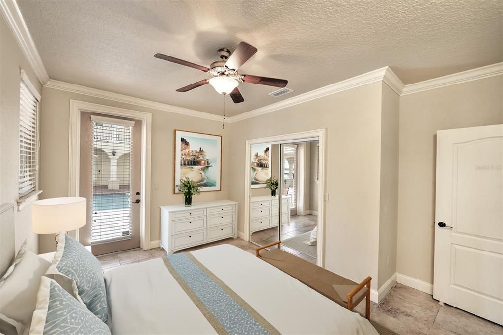 Lower floor, second bedroom has a mirrored glass closet and crown molding.