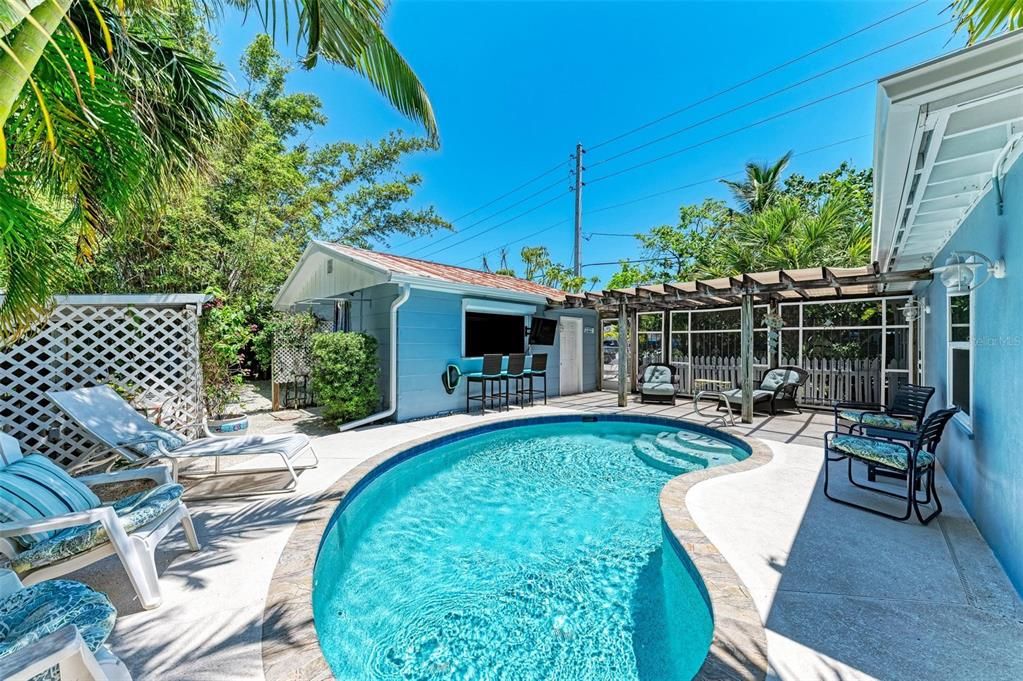 Heated pool, plentiful sunshine, and seating for friends