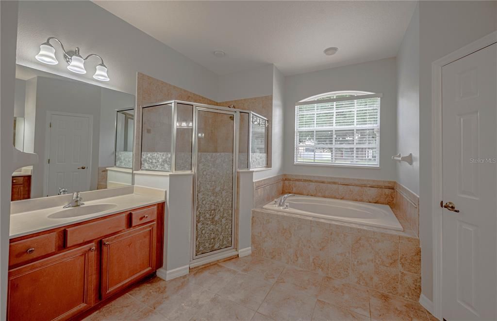 Master bath with a garden tub and walk in shower