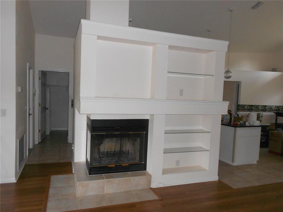 Wood Burning Fireplace and book shelves