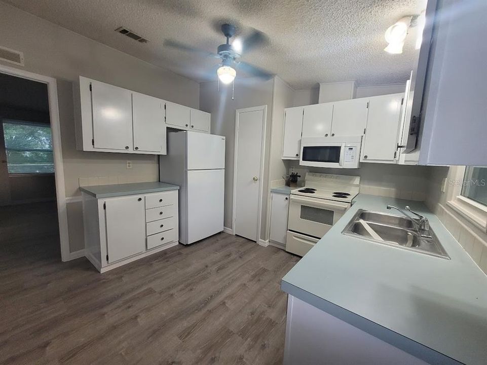 spacious kitchen with new flooring and freshened throughout