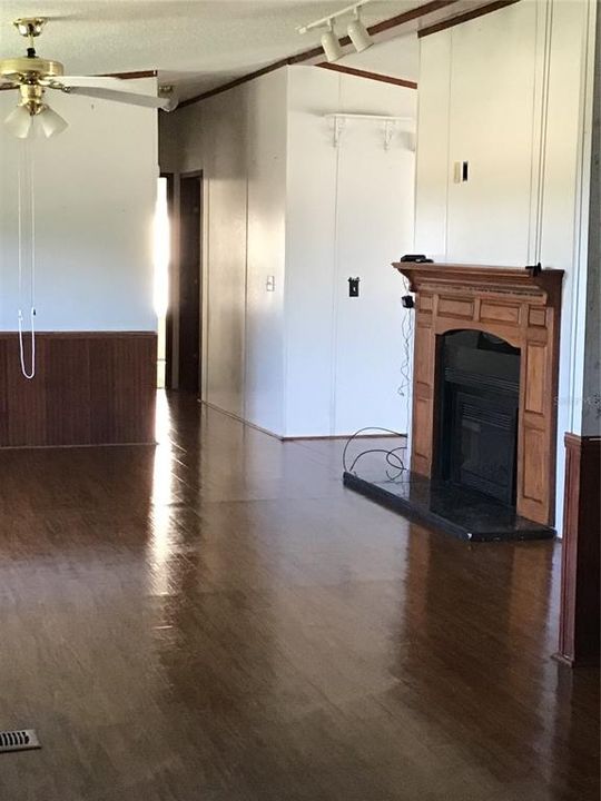 Living room with fireplace open to dining room
