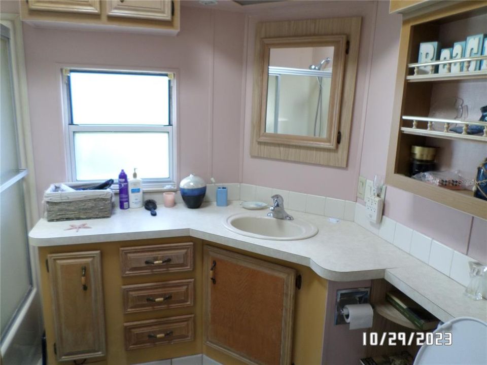 Bathroom with skylight, tub/shower and large vanity.