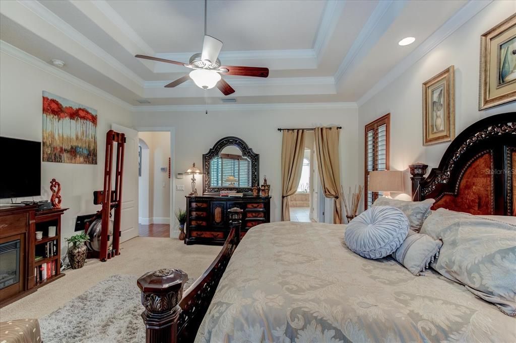 Spacious Master bedroom with crown molding and two wallk in closets.