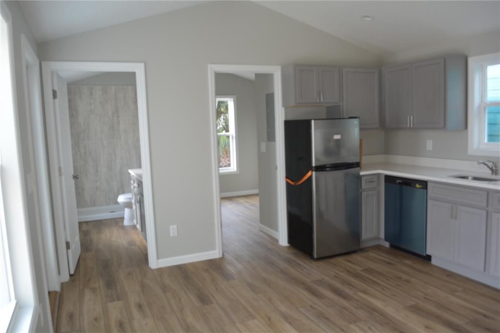 View of kitchen with view of bedroom entrance and bath entrance