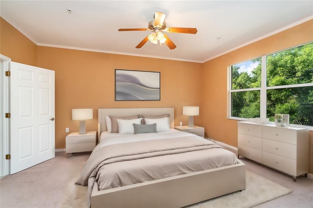 Primary bedroom, spacious enough to accommodate a king-sized bed, offers views of the private preserve.