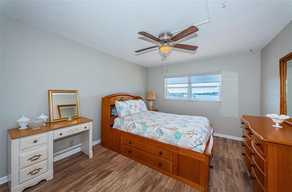 Guest bedroom with luxury vinyl plank flooring and water views flooring, and