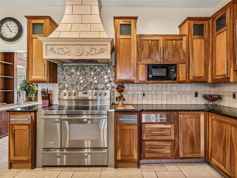 Solid Cherry wood cabinets with granite counters, custom hood vents to outside