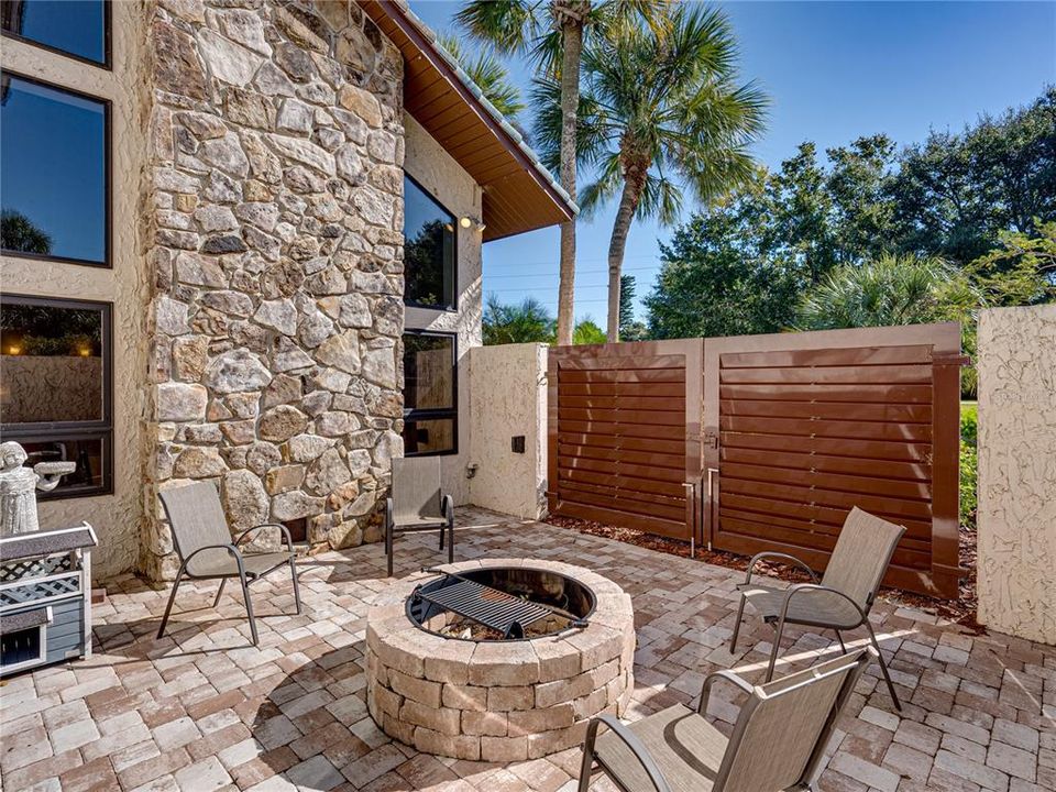 Private outdoor patio with firepit off of game room