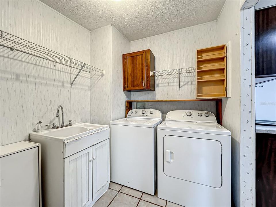 inside laundry room, the washer and dryer will stay