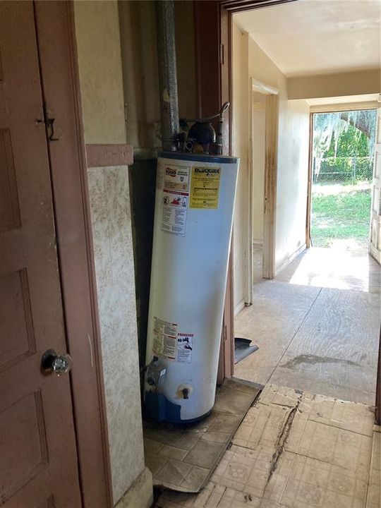 Hot water heater in Kitchen. opening of back door
