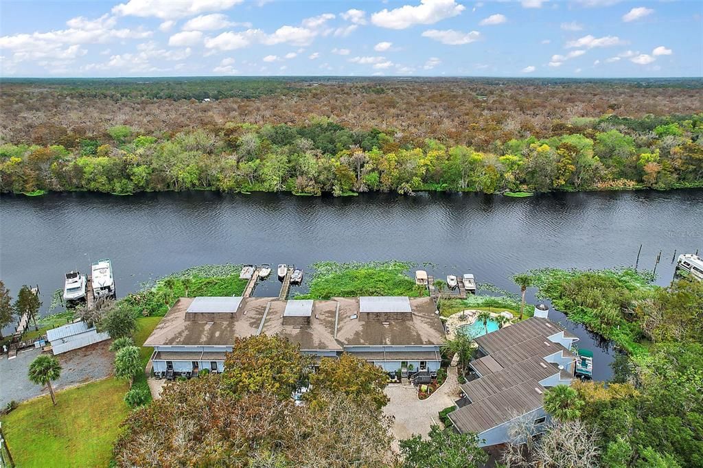 Quaint community of St. Johns River Club, only 16 units in this complex. Unit 1 is in the foreground to the right on canal.  The St. Johns River is shown across the middle  looking westerly over the complex and the river.