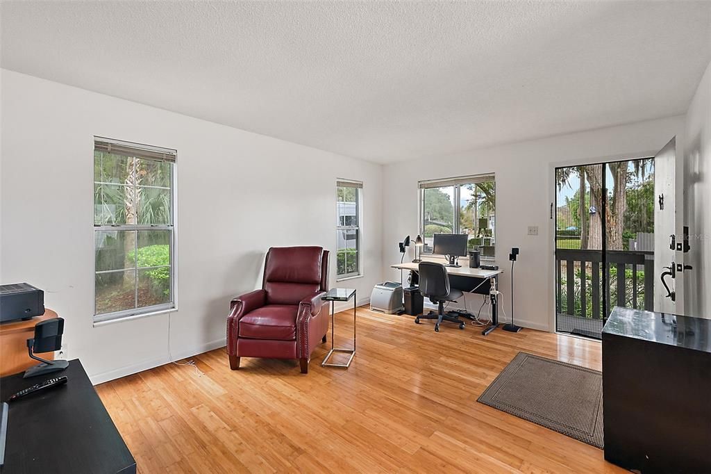 front door leads to cozy living room with bamboo flooring